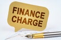 On the business diagram is a pen and a sign with the inscription - Finance Charge Royalty Free Stock Photo