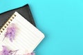 Business diary concept, notebook with purple flowers on bright background, flat lay and copy space photo Royalty Free Stock Photo