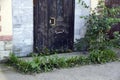 The organization`s front door, long closed and overgrown with trees and grass. Business collapse.