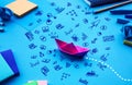 Business direction or goal concepts with boat paper and business doodle icon on worktable background