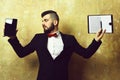 Business director with beard holds tablet and blank open organizer