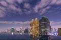 Business district center,Bangkok(Thailand) city scape at nigh,high building with night light and movement clouds.Empty swimming p