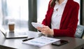 business documents on office table with smart phone and digital tablet and graph financial and woman working at modern office Royalty Free Stock Photo