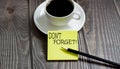 Business don`t forget . Yellow stickers with text on wooden background with coffee