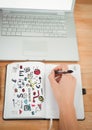 Business doodles on notepad with hand writing and laptop Royalty Free Stock Photo