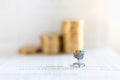 Business E-Commerce and Money Concept. Close up of shopping cart or trolley miniature figure on bank passbook with stack of coins Royalty Free Stock Photo