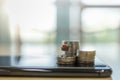 Business E-Commerce and Money Concept. Close up of shopping cart or trolley miniature figure on top of stack of coins on top on Royalty Free Stock Photo