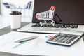 Business e-commerce online and financial accounting concept., Calculator and a pen on data fact sheet in front of personal