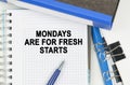 Among the documents, folders, a notebook with the inscription - MONDAYS ARE FOR FRESH STARTS