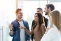 Business, education and office concept - business team with flip board in office discussing something Royalty Free Stock Photo