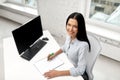 Businesswoman writing to notebook at office Royalty Free Stock Photo