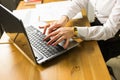 Business, education, people and technology concept - close up of female hands with laptop compute on table