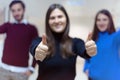 Business, education and sucess concept, Group of Young business people standing and looking at camera with finger up