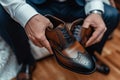 Business elegance hands holding stylish shoes and a wristwatch