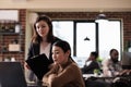 Business employee working with wheelchair user in office