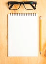 Business essentials. Top view of spiral blank notebook.