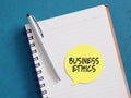 Business ethics reminder note on notebook with pen Royalty Free Stock Photo
