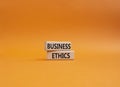 Business ethics symbol. Concept word Business ethics on wooden blocks. Beautiful orange background. Business and Business ethics Royalty Free Stock Photo