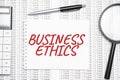 Business Ethics text on paper with calculator,magnifier ,pen on the graph background Royalty Free Stock Photo