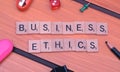 Business ethics words blocks theme on wooden table