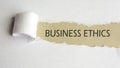 business ethics. words. text on gray paper on torn paper background. Royalty Free Stock Photo