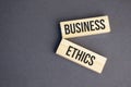 business ethics words on wooden blocks on yellow background. Business ethics concept