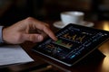 Business executive analyzing stock market performance on a high-tech tablet screen Royalty Free Stock Photo