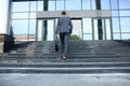 Business executive with briefcase going up the stairs. Royalty Free Stock Photo