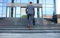 Business executive with briefcase going up the stairs. Royalty Free Stock Photo