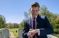 Businessman, Executive in blue suit using mobile, cell phone in the park Royalty Free Stock Photo