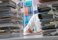 Businessman working in the office and piles of paperwork Royalty Free Stock Photo