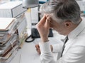 Businessman working in the office and piles of paperwork Royalty Free Stock Photo