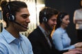 Business executives with headsets using computers at desk Royalty Free Stock Photo