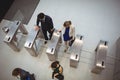 Business executives passing through turnstile gate