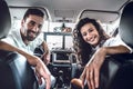 Young smiling couple sitting in the new car Royalty Free Stock Photo