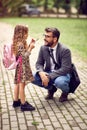 Business father taking child to primary school Royalty Free Stock Photo