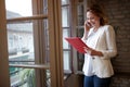 Business female in company talking on cell phone with client Royalty Free Stock Photo