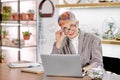 Business female sitting with laptop in light room