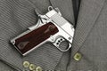 Business fight. Semi-automatic handgun in business suits, 45 pistol. Royalty Free Stock Photo