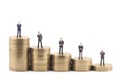 Business figures on stacks of coins Royalty Free Stock Photo