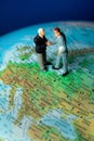 Business Figurines on Globe