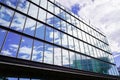 Business and finance background of modern glass windows building with sky cloud reflection in sunny day Royalty Free Stock Photo