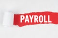 Behind torn white paper on a red background, the text - PAYROLL