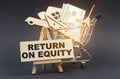 On a black background, a shopping cart, an easel and a sign with the inscription - RETURN ON EQUITY