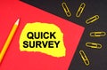 On a black background, there are yellow paper clips and a sheet of paper with the inscription - QUICK SURVEY Royalty Free Stock Photo