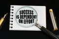 On the black surface there is a magnifying glass and a notebook with the inscription - SUCCESS DEPENDS ON EFFORT