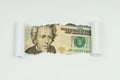 An image of a 20 dollar bill is visible in the torn hole of a sheet of paper Royalty Free Stock Photo