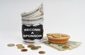 There is a bank with money on the table, it says - BECOME A SPONSOR