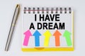 On a white background lie a pen and a notebook with the inscription - I HAVE A DREAM