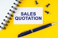 On a yellow background lies a notebook, a pen and a business card with the inscription - Sales quotation